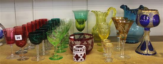 A collection of Victorian and later coloured drinking glasses to include a citrine heavy cut jug